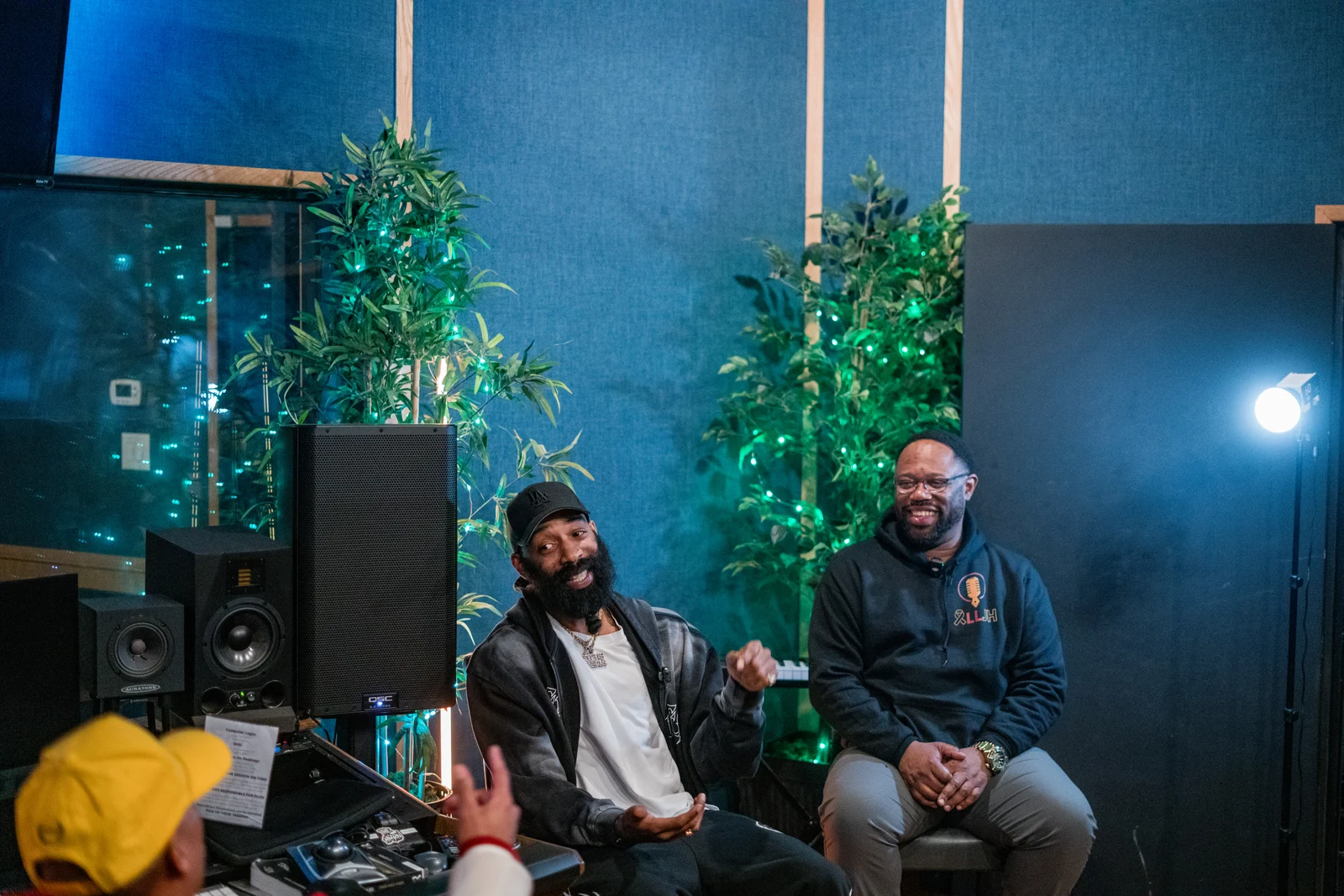 Ciz, seated on the right in a black hoodie, at a Creative Space event.
